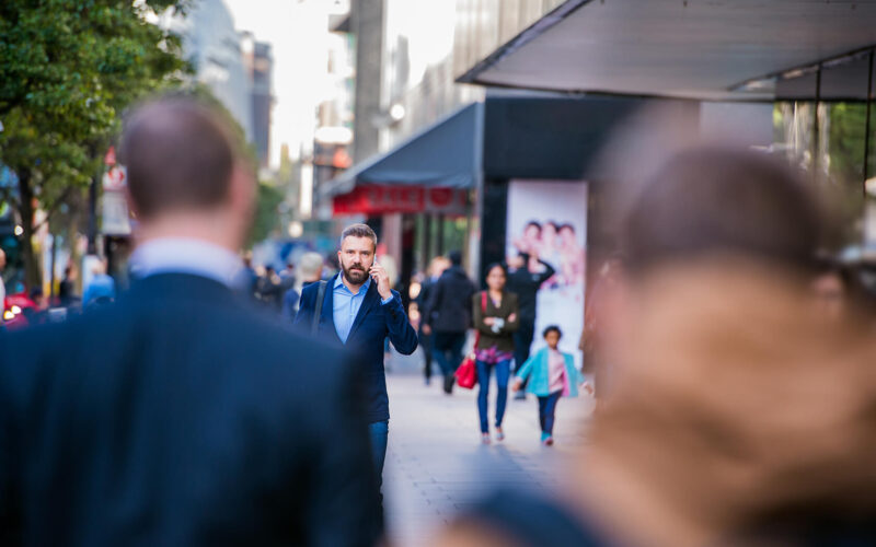 hipster-manager-with-smart-phone-walking-in-the-PFKTPR9(1) Retail & Distribution